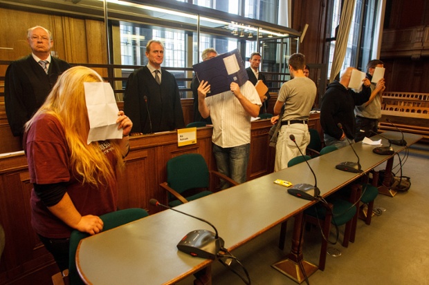 The accused Neo-Nazis hide their faces in Berlin courtroom, Germany. A court hearing started against a group of ten Neo-Nazis, who are accused of jointly operating an extreme right-wing internet radio named Irminsul. Photograph: Theo Schneider/Demotix/Corbis