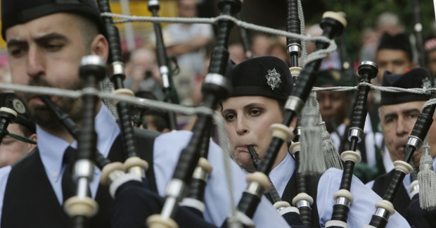 Pipe bands march through Glasgow ahead of the World Pipe Band Championships. The World Pipe Band Championships being held this weekend in city will see 225 bands bring 8,000 pipers and drummers to play in front of thousands of spectators. Photograph: Danny Lawson/PA