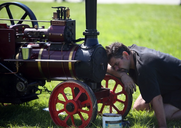 An exhibitor prepares a miniature steam engine to show at the Cornish Steam and Country Fair at the Stithians Showground near Penryn. The annual show, now in 58th year, is one of Cornwall's largest outdoor events and is one of the UK's most popular and respected steam rallies. Photograph: Matt Cardy/Getty Images