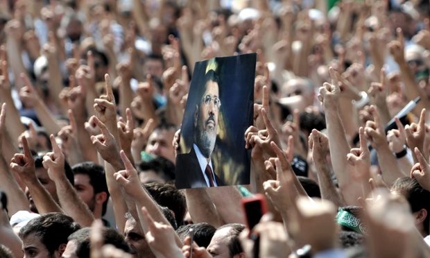 Elsewhere at Eyup Sultan mosque in Istanbul a poster of Mohamed Morsi is held up by a protestor during a demonstration condemning the deadly crackdown in Cairo.