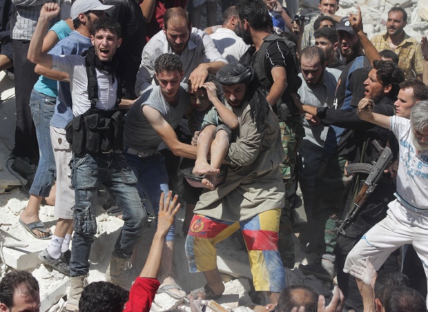 Free Syrian Army fighters and civilians help a wounded boy rescued from under rubble after what activists said was shelling by forces loyal to Syria's President Bashar al-Assad in Aleppo's Bustan al-Qasr district. Photograph: Stringer/Reuters
