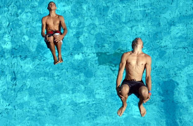Participants take a test jump during the German Splash Diving Championships at Sommerbad Neukoelln in Berlin, Germany,. The public bath will host this year's German and World Splash Diving Championships. Photograph: Matthias Balk/dpa/Corbis