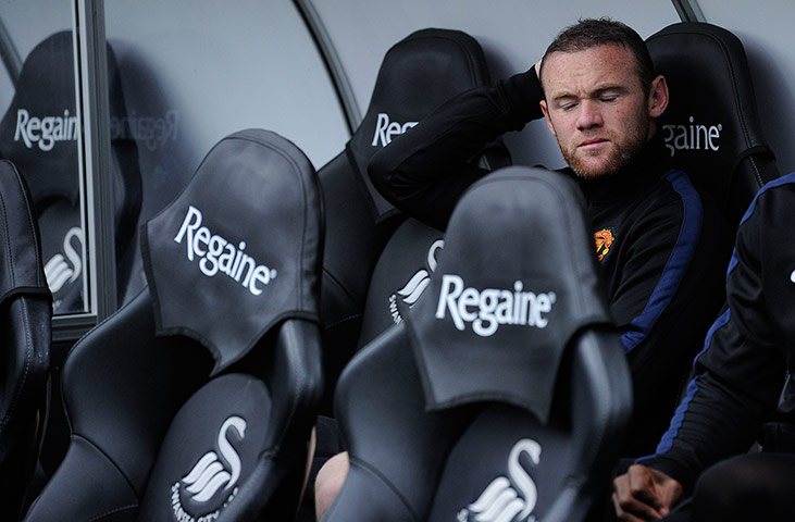 Swansea v United: Wayne Rooney doesn't look too happy sat on the bench