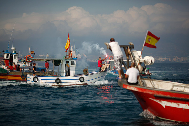 Gibraltar protests: Leoncio Fernandez, head of the La Linea fishermen, holds a red flare to mar