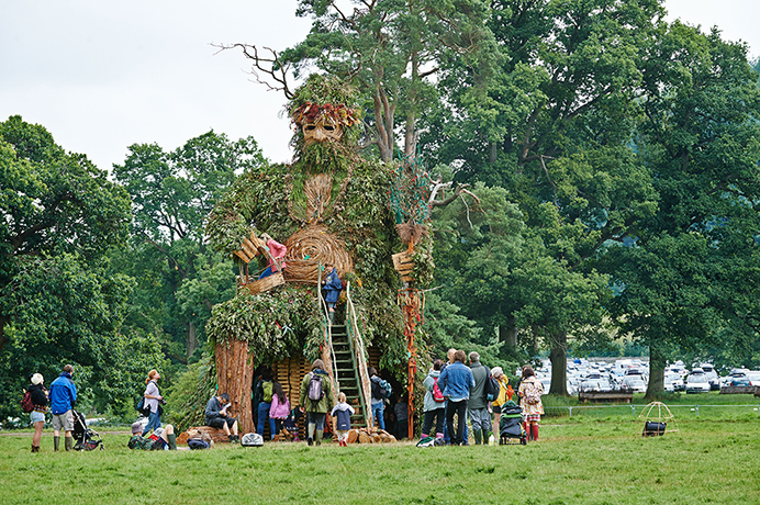 Festivals: Festival goers hang out under the giant green man at Green Man Festival 