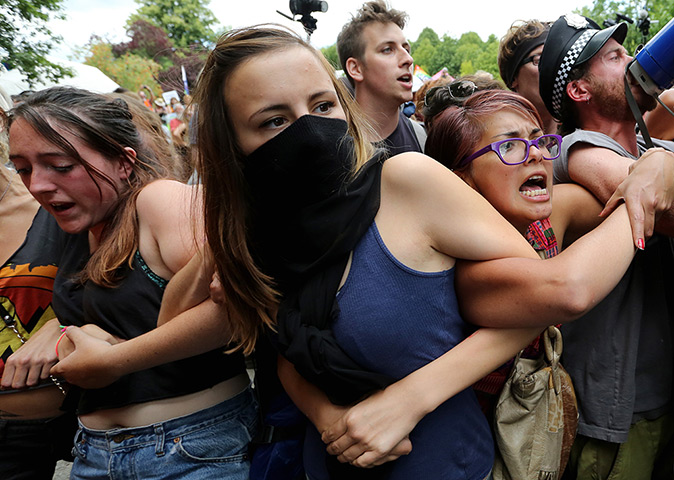 Fracking protests: Activists link arms to resist police officers as they clear the road outsid