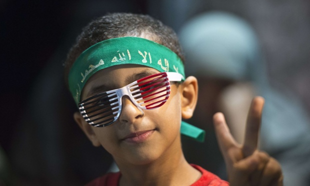 A young supporter of deposed president Mohammed Morsi attends at the open sit-in protest with his family outside Rabaa al-Adawiya mosque in Cairo, Egypt.