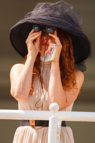 More sport, this time involving big hats, binoculars and smartphones. A racegoer follows the horses on day four of Glorious Goodwood at Goodwood Racecourse, Chichester.