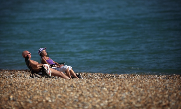 Still lives: A couple enjoy the warm weather on Eastbourne beach.