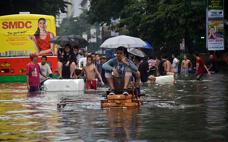 Manila floods: Major roads were impassable as floodwaters reached waist or neck deep in so