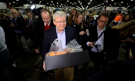 Prime Minister Kevin Rudd carries a box of fruit and vegetables he bought at Flemmington markets in Sydney, Friday, Aug. 23, 2013.