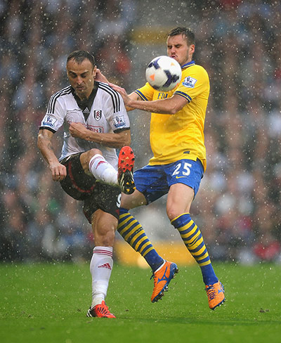 Saturday Round up: Dimitar Berbatov hoofs the ball away from Carl Jenkinson