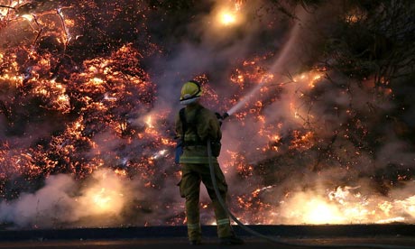 A firefighter douses the flames of the Rim Fire in Groveland, California. 