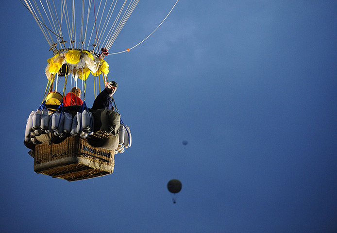Weekend in pictures: Essey, France: Pilots in the basket of their balloon as they take part in t