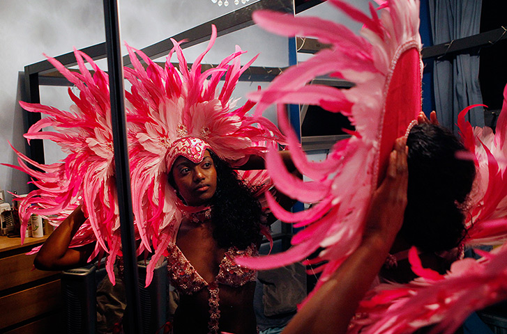 Notting Hill carnival: Rochelle Birbal, a member of the Funatiks Mas Band, tries on her costume