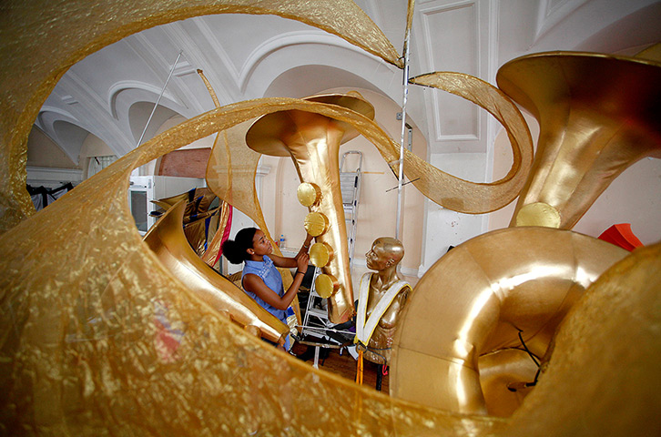 Notting Hill carnival: Mahogany Mas Band member Anissa Gilbert adjusts the buttons on a giant costume
