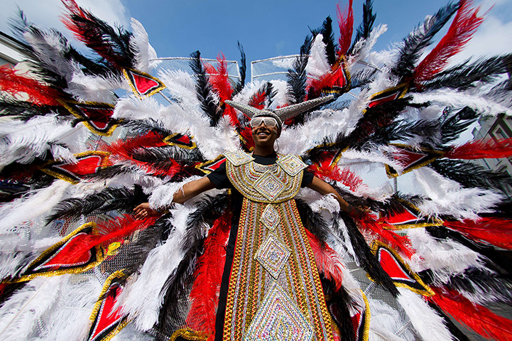 Notting Hill carnival: A participant spreads their feathered costume