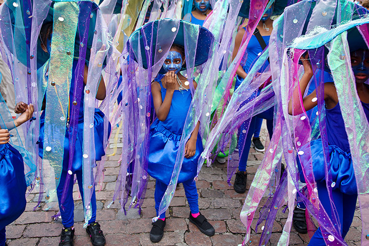 Notting Hill carnival: A young girl in costume prepares to take part in the parade on children's day