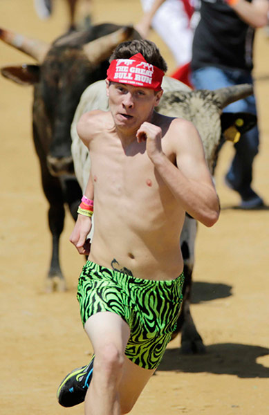 us bull run: A participant runs and dodges bulls in the Great Bull Run in Petersburg