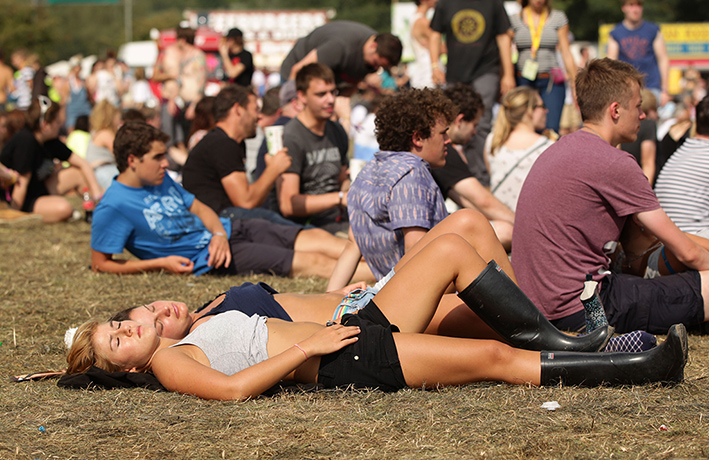 Reading festival: Festival goers sunbathe on Sunday at Reading