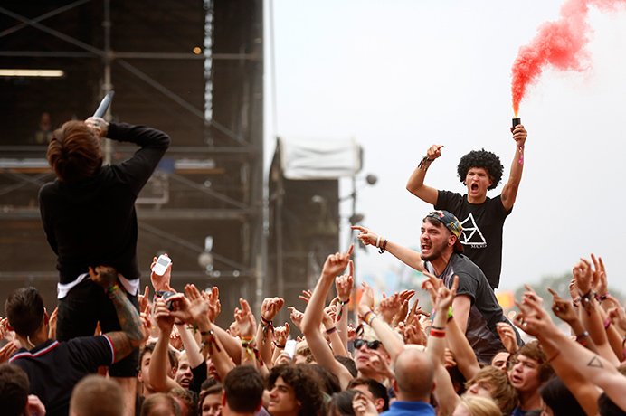 Reading festival: A music fan lights a flare with Oliver Sykes of Bring Me the Horizon