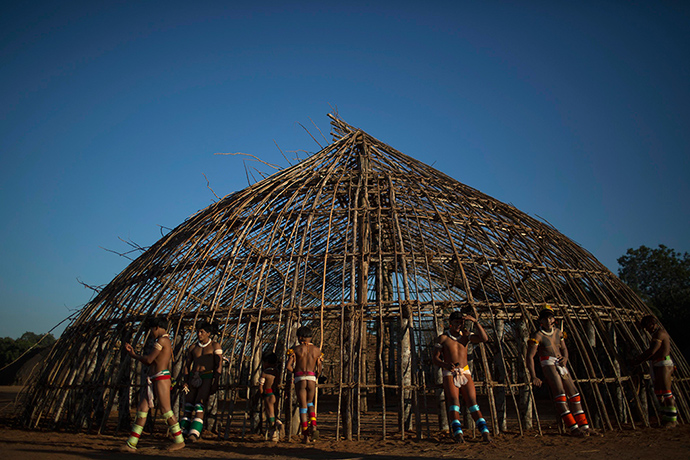 Waura Indian ritual : Waura Indian men wait outside a hut for the start of the ceremonies of this