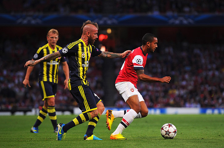 arsenal: Theo Walcott holds off the challenge of Raul Meireles
