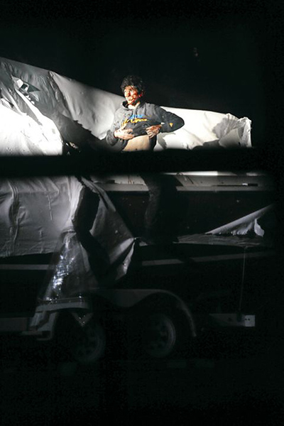 Boston Marathon pics: Dzhokhar Tsarnaev holds up his shirt as he prepares to give himself up.