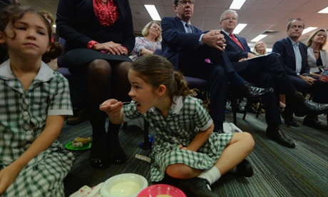 A school girl enjoys her breakfast ahead of Prime Minister Kevin Rudd (right) addressing the Queensland Teachers' Union in Brisbane, Wednesday, Aug. 28, 2013.