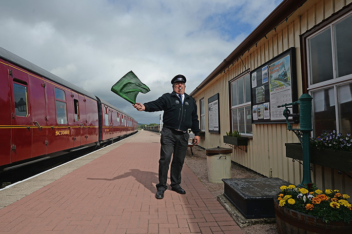 Highland Mainline: Guard Brian Burgess waves off the train