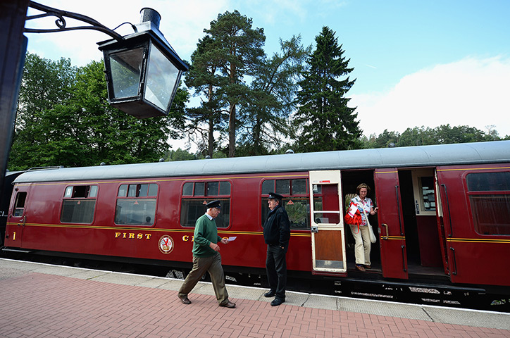Highland Mainline: Guard Brian Burgess waves off the train 