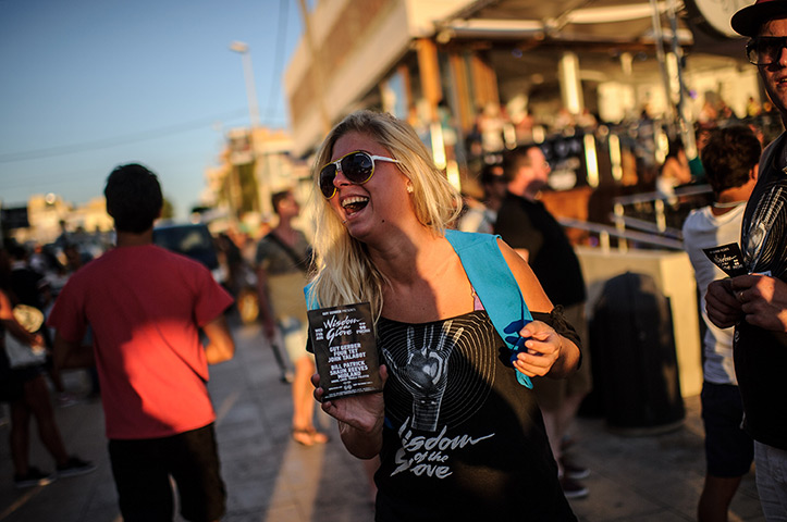 Ibiza: A girl gives out flyers in front of Cafe del Mar in Sant Antonio 