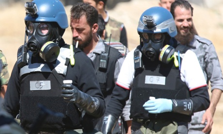 Meanwhile UN chemical weapons experts wearing gas masks carry samples from one of the sites of an alleged chemical weapons attack in the Ain Tarma neighbourhood of Damascus.