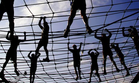 Athletes crossing a rope bridge 