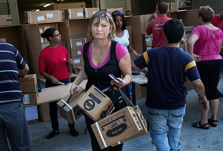 Israel preparations: An Israeli woman carries gas masks at a distribution centre in Haifa