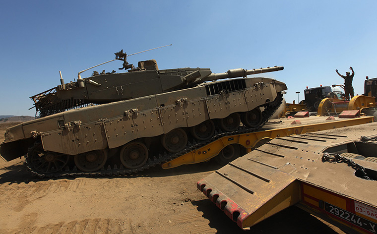 Israel preparations: An Israeli soldier directs a tank in the Golan Heights
