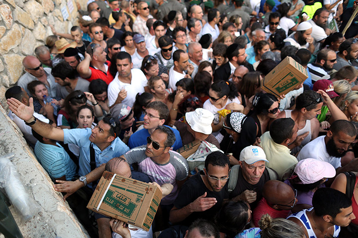 Israel preparations: Hundreds of Israelis queue to collect gas mask kits in Haifa
