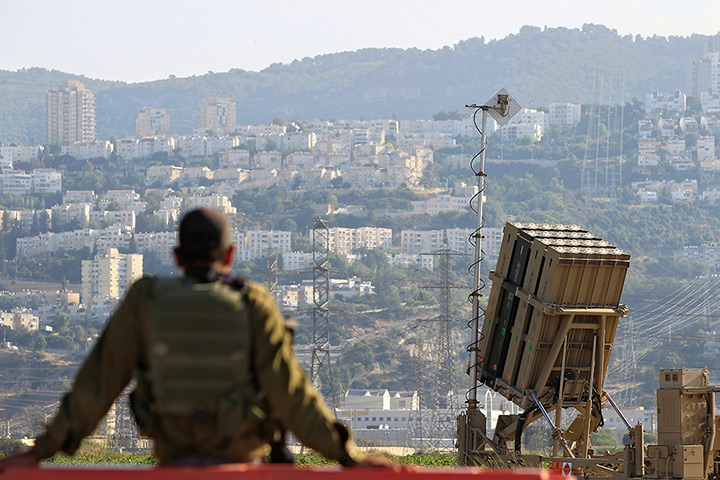 Israel preparations: An Israeli soldier sits near an Iron Dome rocket interceptor battery deploy