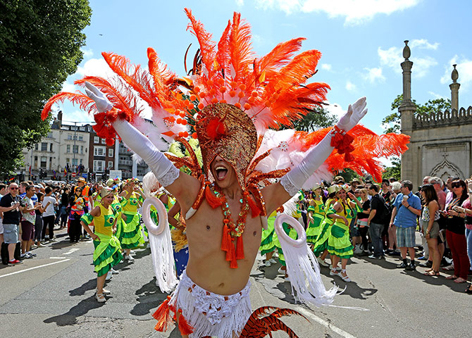 Brighton Pride: A man in carnival dress dances at Brighton and Hove Pride
