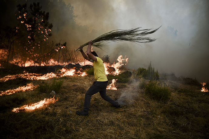 Wildfires in Portugal: TOPSHOTS A local tries to extinguish a w