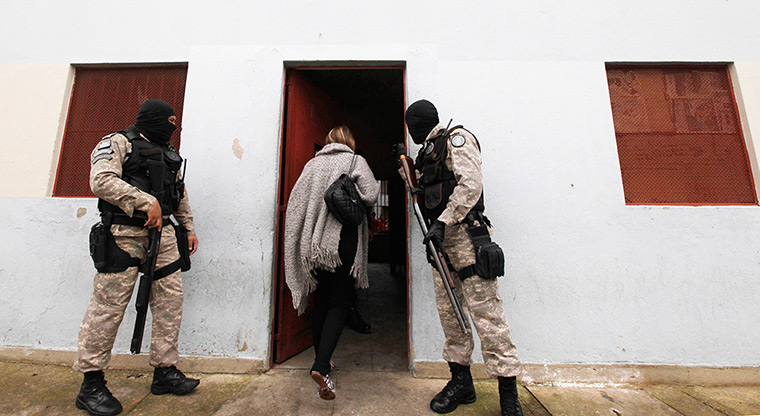 Prison knitting: Guards escort fashion designer Raquel Guimaraes into the prison