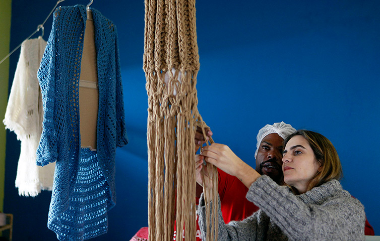 Prison knitting: Raquel Guimaraes supervises a prisoner knitting for her