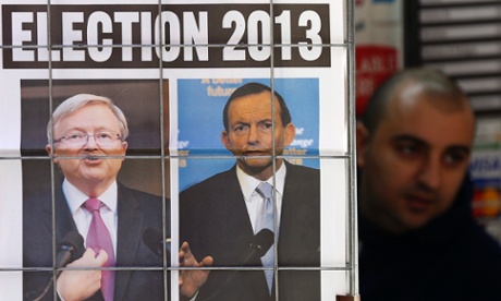 A man walks behind an advertisement for a newspaper with pictures of Australian Prime Minister Kevin Rudd (L) and opposition leader Tony Abbott in central Sydney August 5, 2013.