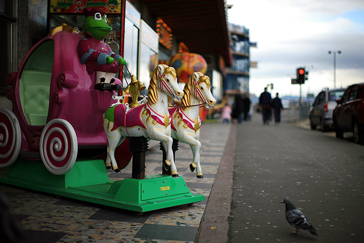 UK Seaside Towns: A children's fun ride waits for trade outside an amusement arcade