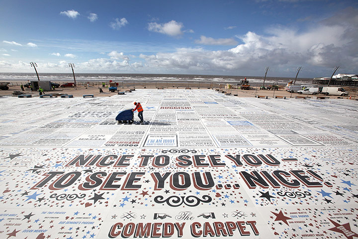 UK Seaside Towns: A worker sweeps the 'Comedy Carpet' in Blackpool