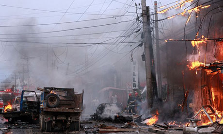 Vehicles and buildings burn after a bombing in Cotabato City, Philippines