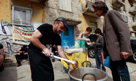 Constantinos Polychronopoulos ladels out food at a soup kitchen in Athens