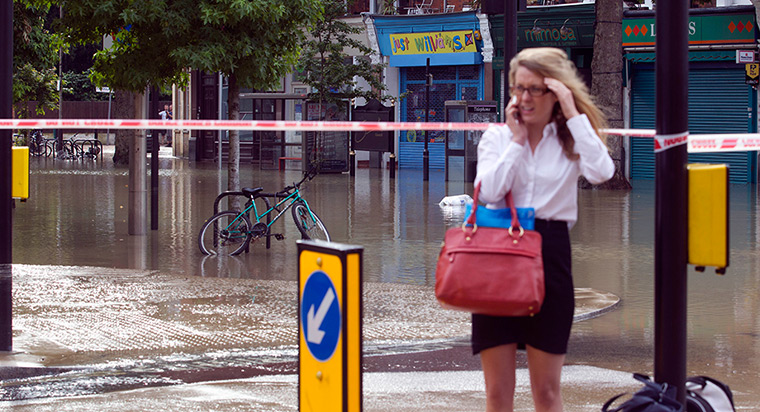 Herne Hill flood: A woman talks on her phone at Half Moon Lane