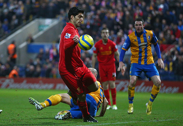 Luis Suárez of Liverpool appears to control the ball with his hand 