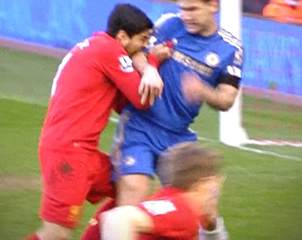 Luis Suarez biting into the arm of Chelsea defender Branislav Ivanovic